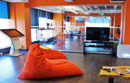 orange bean bag chair in cool work tech company work space